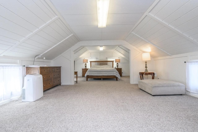 bedroom featuring lofted ceiling, multiple windows, and carpet