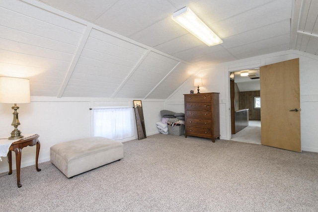 interior space featuring carpet floors, vaulted ceiling, and a wealth of natural light