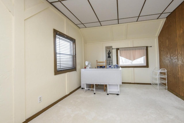 interior space with baseboards, a healthy amount of sunlight, and a drop ceiling