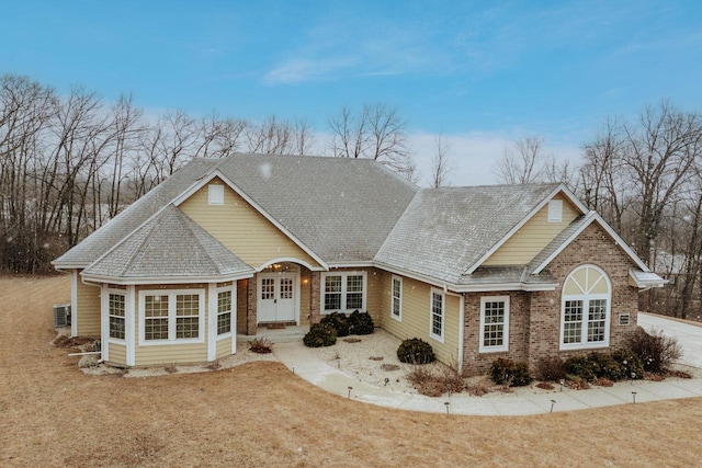 view of front of house with a front yard and french doors