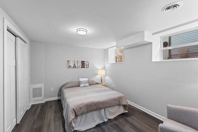 bedroom featuring dark wood-type flooring and a closet