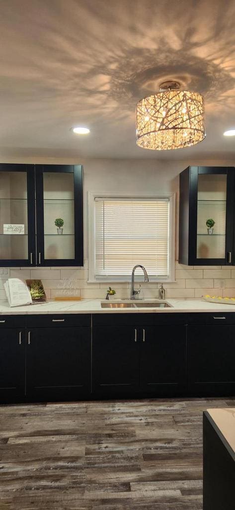 bathroom with vanity, hardwood / wood-style flooring, and tasteful backsplash