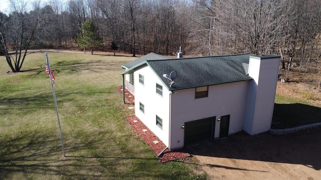 view of side of home with a garage and a yard