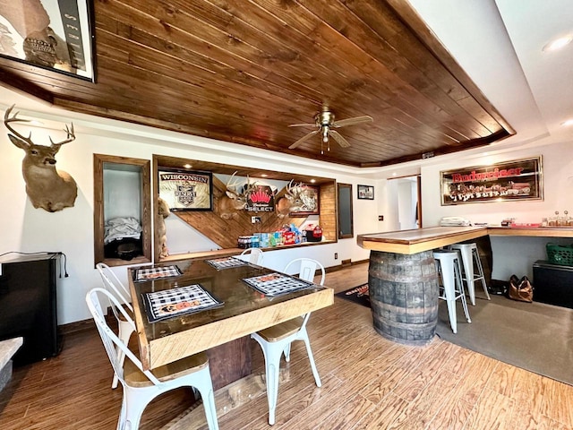 bar featuring hardwood / wood-style floors, wooden ceiling, ceiling fan, and a tray ceiling