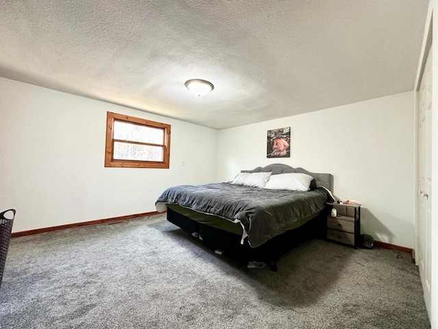 carpeted bedroom featuring a textured ceiling