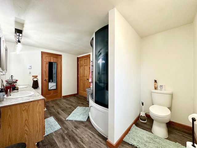 full bathroom featuring vanity, hardwood / wood-style floors, independent shower and bath, and toilet