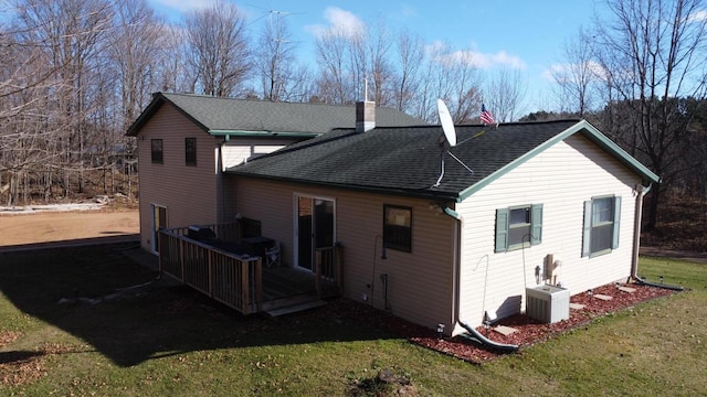 back of house featuring a wooden deck, a lawn, and central air condition unit