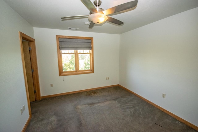 carpeted spare room with ceiling fan