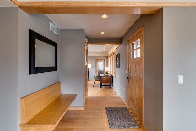 foyer entrance with light wood-type flooring, visible vents, baseboards, and recessed lighting