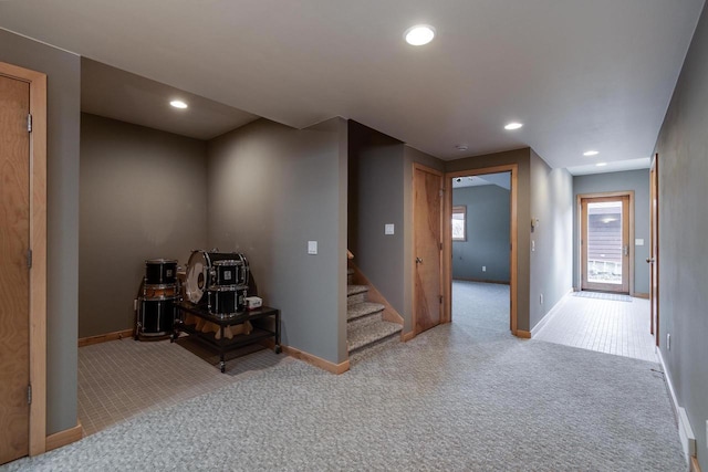 below grade area featuring carpet floors, stairway, and recessed lighting