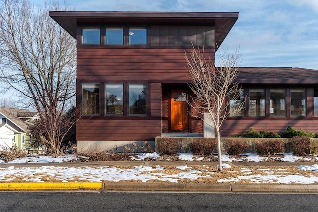 view of front of home with a sunroom