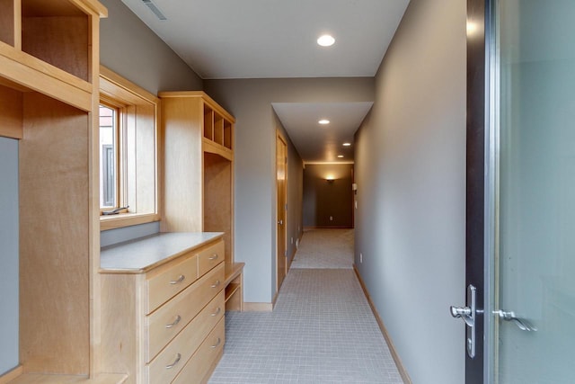 hallway with baseboards, visible vents, and recessed lighting