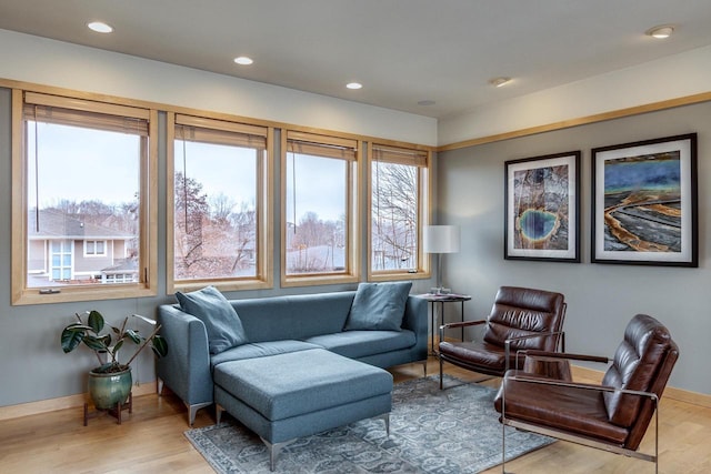 living area with a wealth of natural light, recessed lighting, and wood finished floors