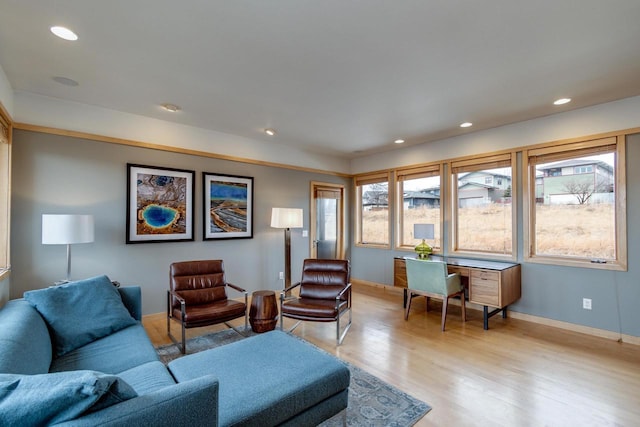 living room featuring baseboards, light wood-style flooring, and recessed lighting