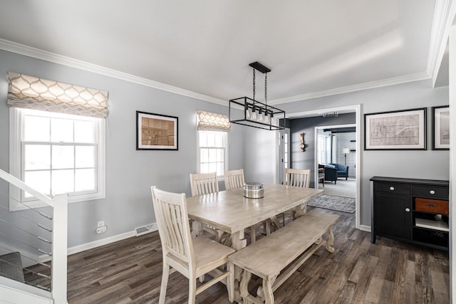 dining room featuring ornamental molding and dark wood-type flooring