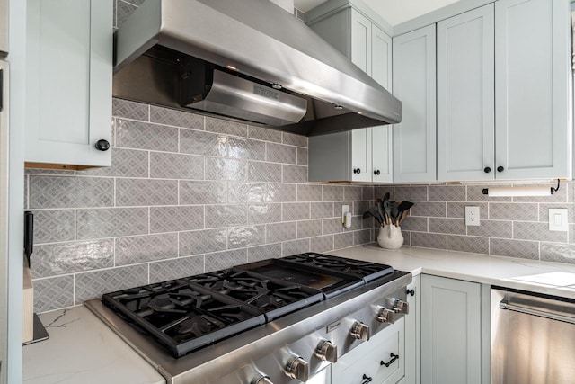 kitchen featuring backsplash, stainless steel appliances, wall chimney range hood, and light stone counters