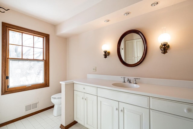 bathroom featuring toilet and vanity