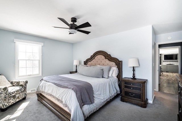 bedroom featuring ceiling fan and carpet