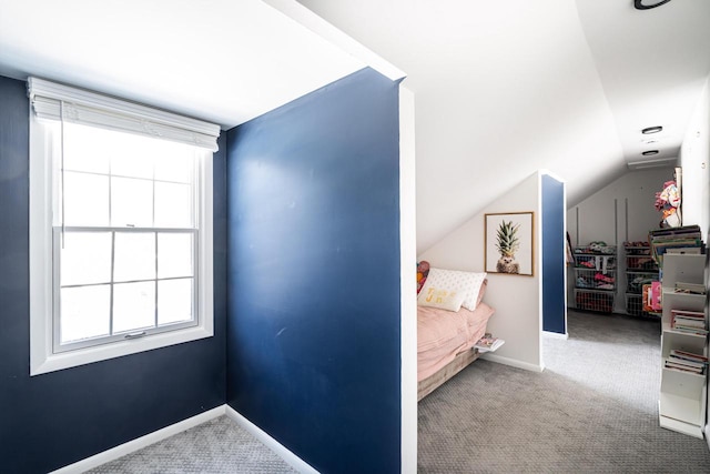 carpeted bedroom featuring lofted ceiling