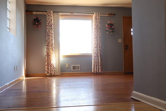 empty room with hardwood / wood-style flooring