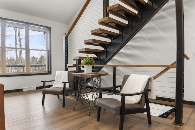 living area with lofted ceiling and hardwood / wood-style floors