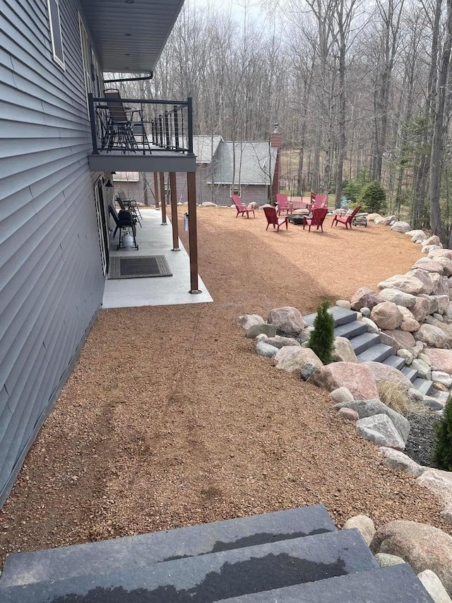 view of yard with a fire pit and a patio