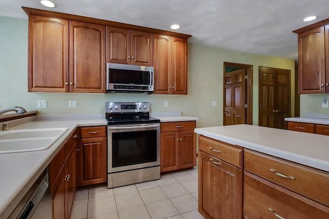 kitchen with light tile patterned flooring, stainless steel appliances, and sink