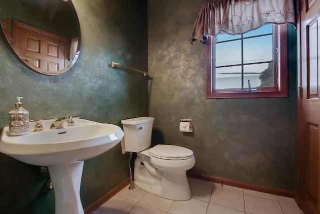 bathroom featuring toilet and tile patterned flooring