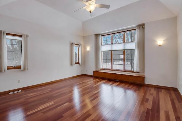 unfurnished room featuring wood-type flooring, ceiling fan, and plenty of natural light