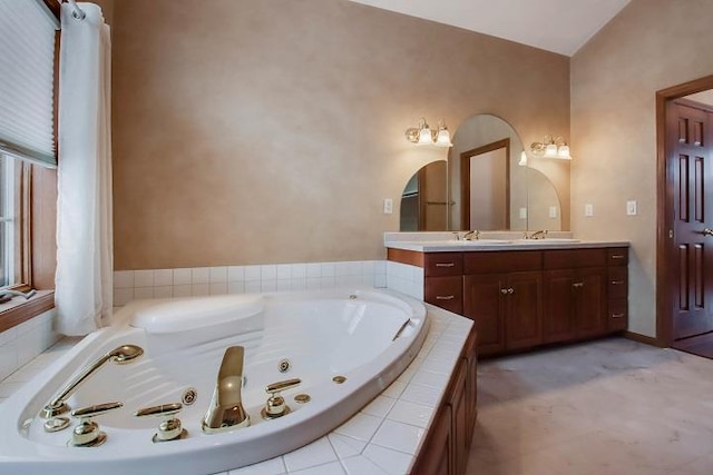 bathroom featuring vanity and a relaxing tiled tub