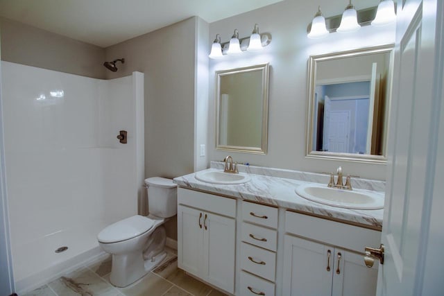 bathroom with vanity, toilet, and a shower