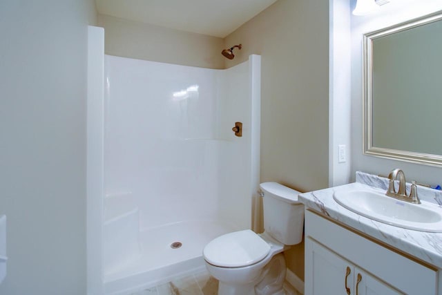 bathroom with walk in shower, vanity, and toilet