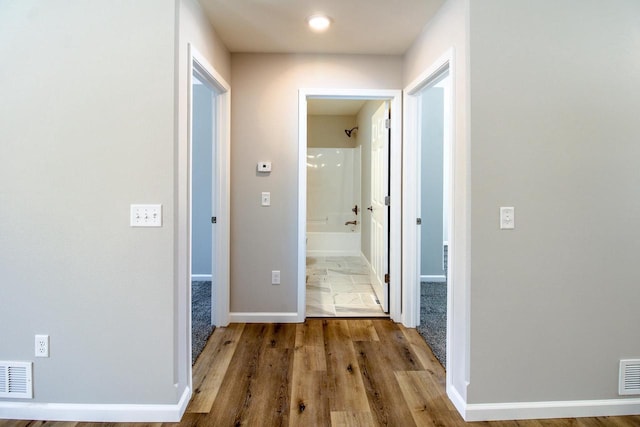 corridor featuring hardwood / wood-style floors