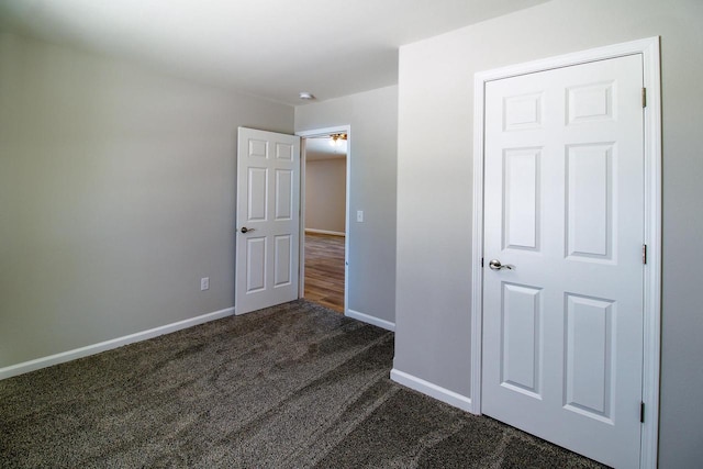 unfurnished bedroom featuring dark colored carpet