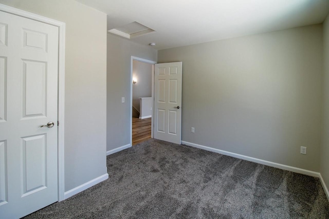 unfurnished bedroom with dark carpet