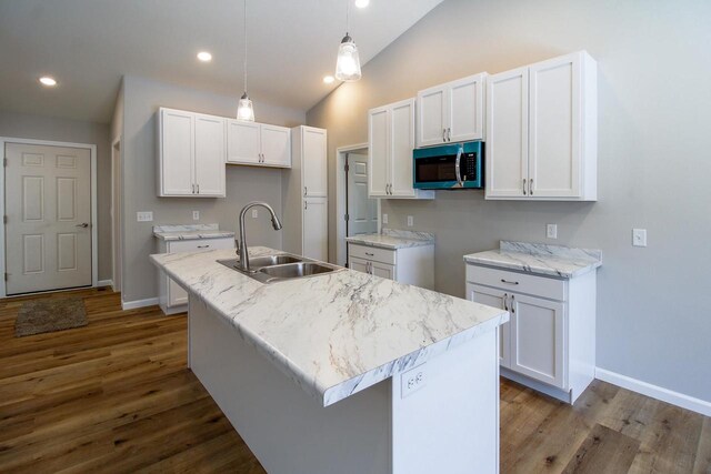 kitchen featuring sink, white cabinets, and a center island with sink