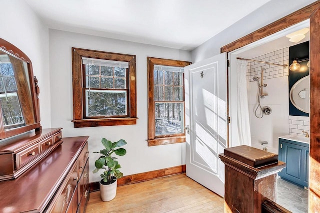 doorway to outside with sink and light hardwood / wood-style flooring