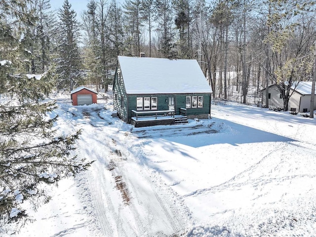 view of front of house with a garage and an outbuilding