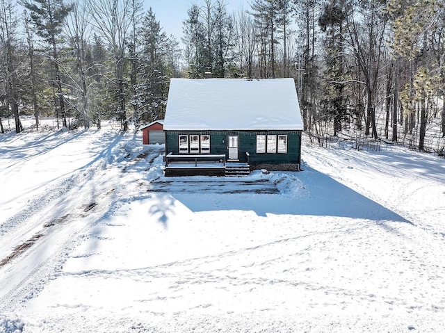 view of front of home with a garage and an outdoor structure