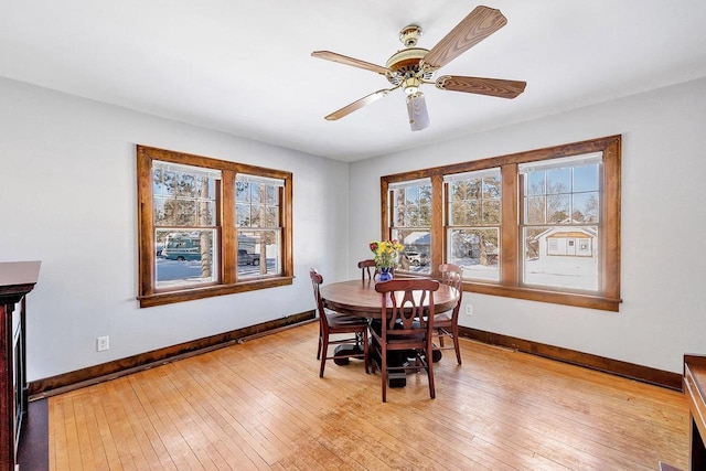 dining space featuring ceiling fan and light wood-type flooring