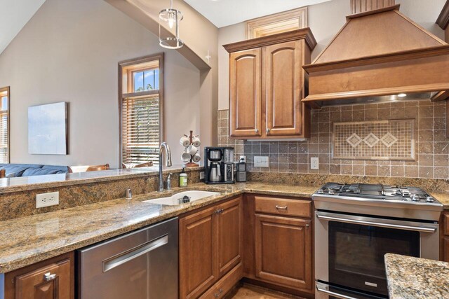 6507 Willow Ct, Waterford, WI 53185 - kitchen featuring premium range hood, tasteful backsplash, sink, light stone counters, and stainless steel appliances