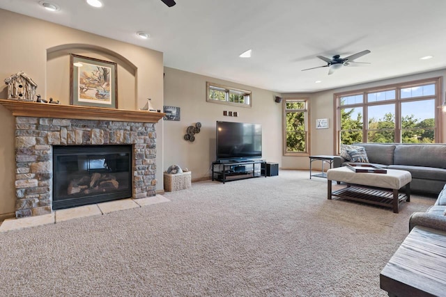 6507 Willow Ct, Waterford, WI 53185 - living room featuring ceiling fan, a stone fireplace, and light carpet