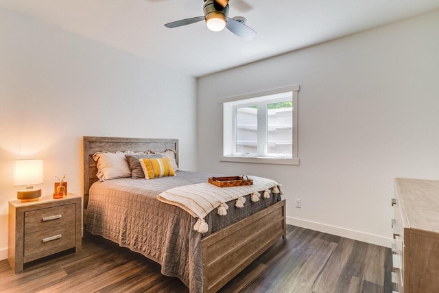 bedroom with dark wood-style floors, ceiling fan, and baseboards