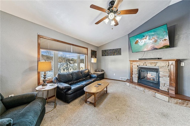 living room with ceiling fan, carpet flooring, lofted ceiling, and a fireplace