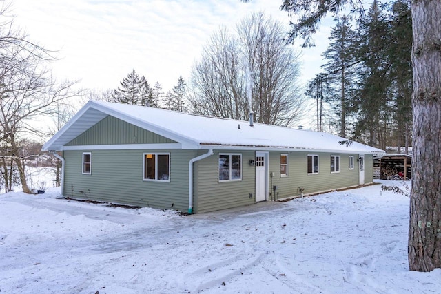 view of snow covered back of property