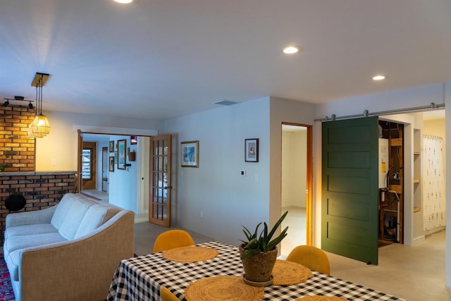 dining room with a barn door and french doors