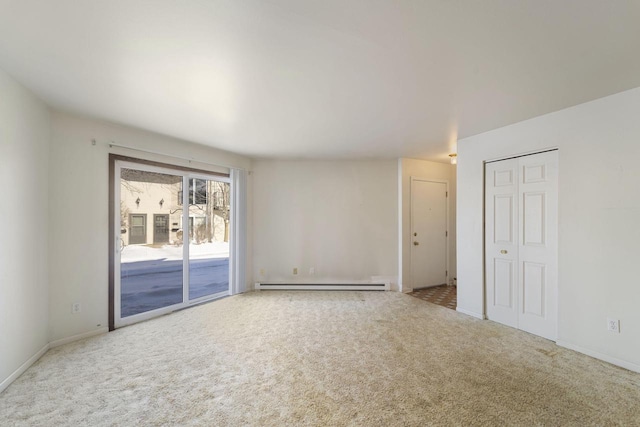 carpeted empty room with a baseboard radiator