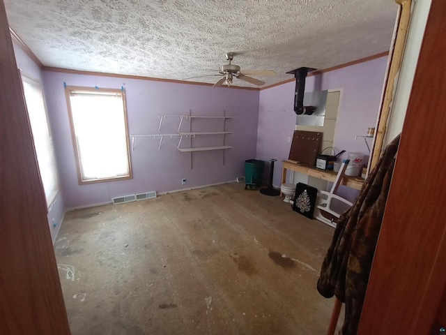 33315 State Highway 13, Bayfield, WI 54814 - unfurnished living room featuring crown molding, ceiling fan, and a textured ceiling