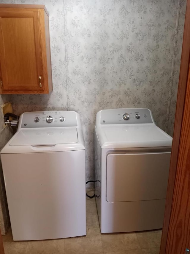 33315 State Highway 13, Bayfield, WI 54814 - laundry room with wallpapered walls, washer and clothes dryer, and cabinet space