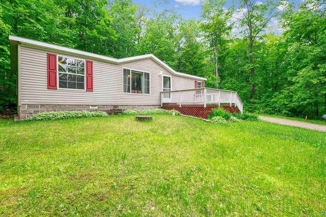 33315 State Highway 13, Bayfield, WI 54814 - view of front facade with a deck, a front lawn, and crawl space